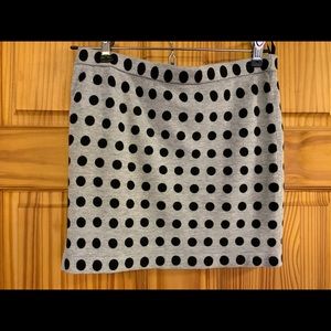 Mini skirts.  1 black, 1 black/gray polka dots.